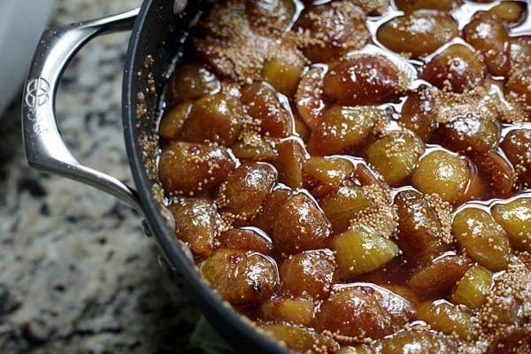 Cooked down figs in a black nonstick pot on a countertop