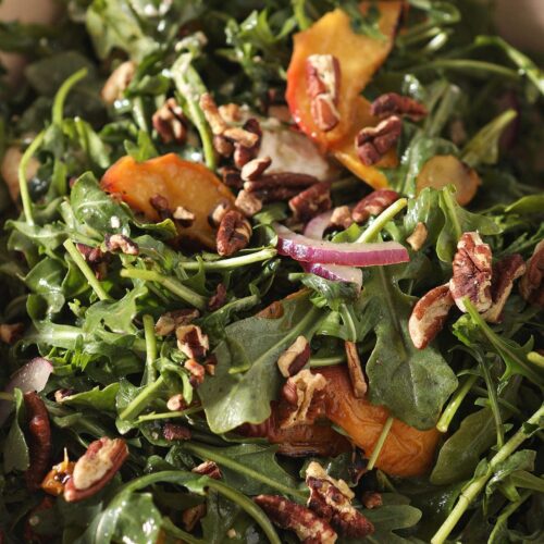 Close up of an arugula salad with peaches