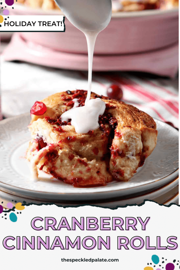 spoon drizzling frosting on a cinnamon roll with the text cranberry cinnamon rolls