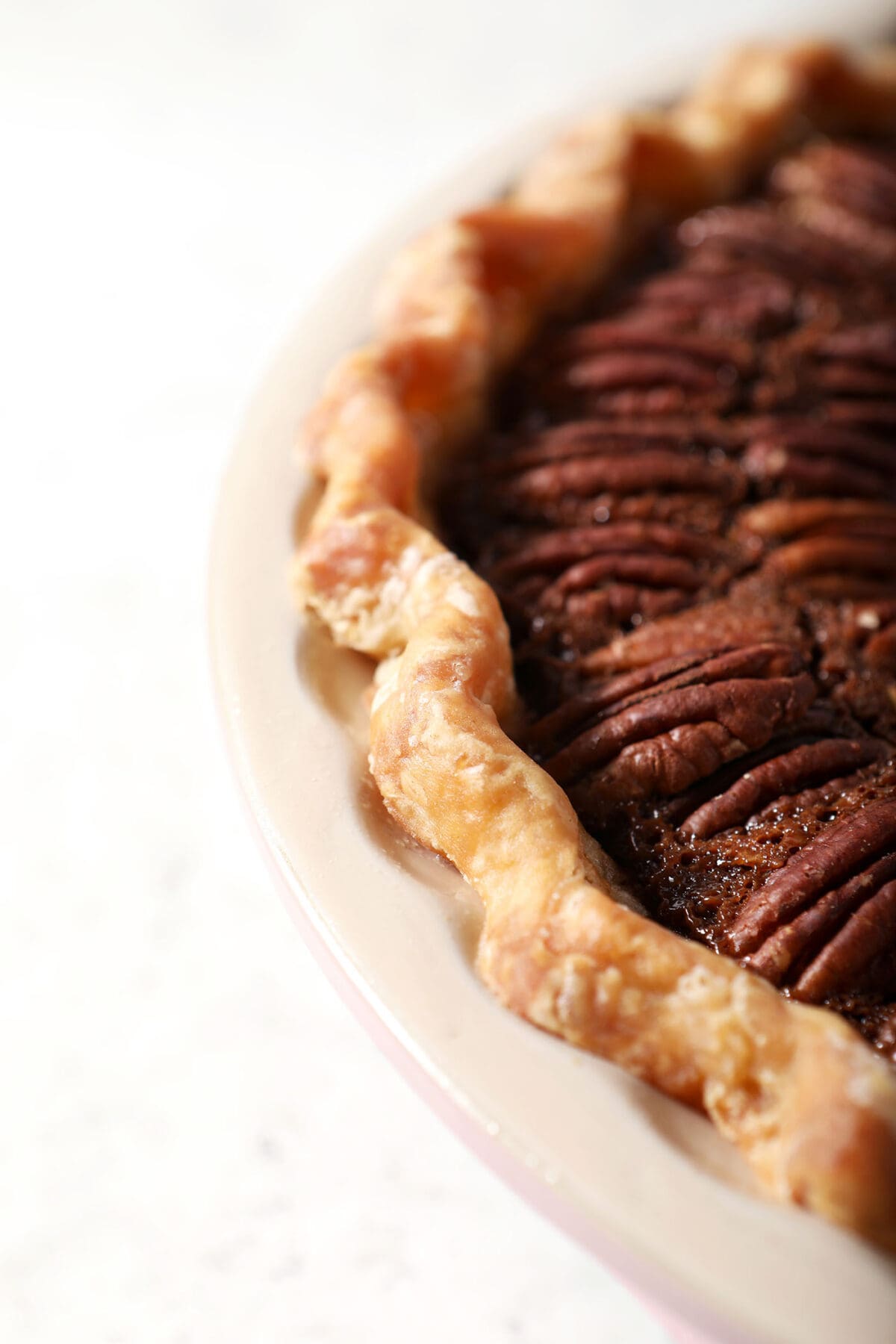 Close up of butter pie crust on a pecan pie
