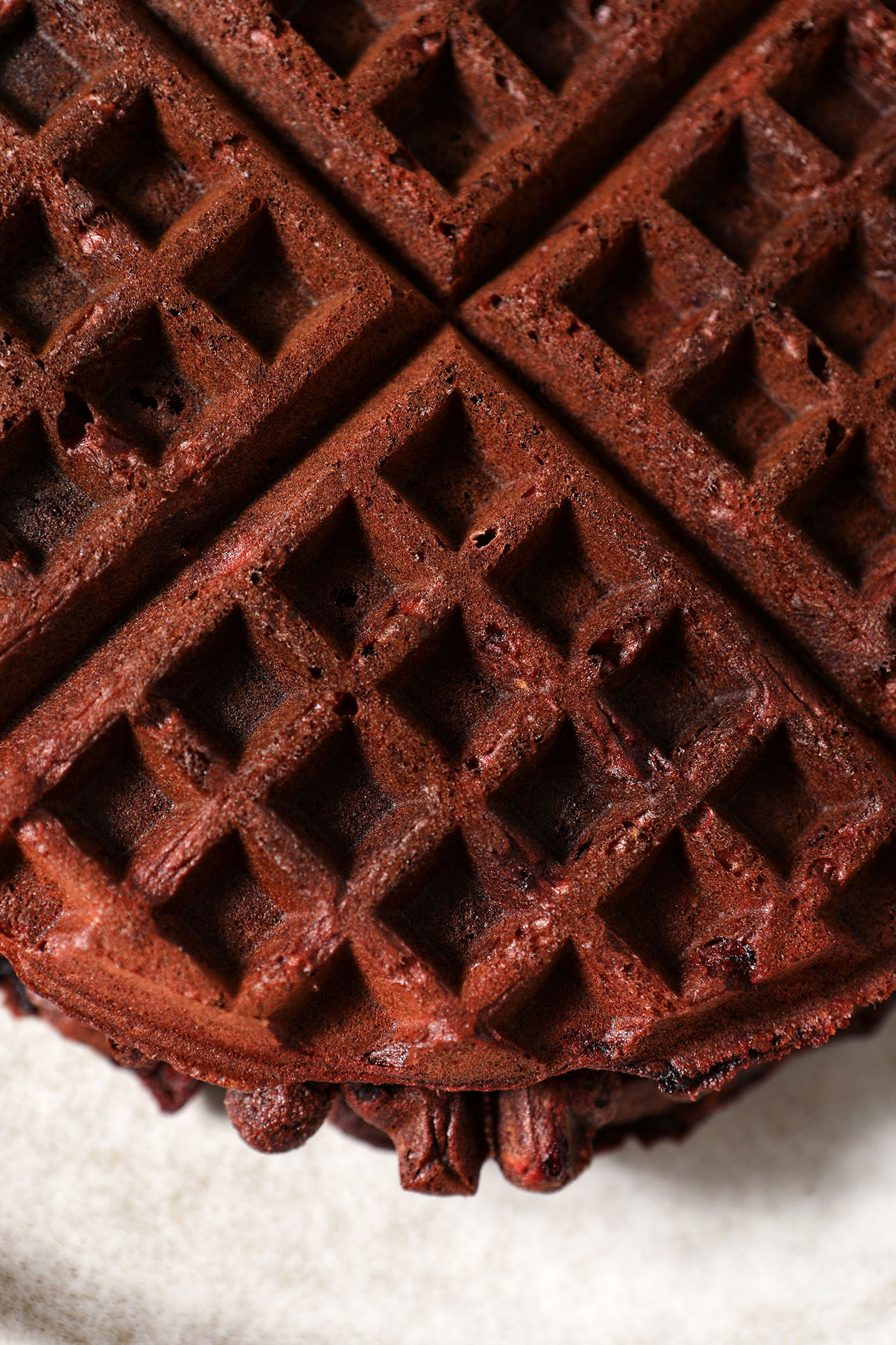 Close up of a red velvet waffle from above